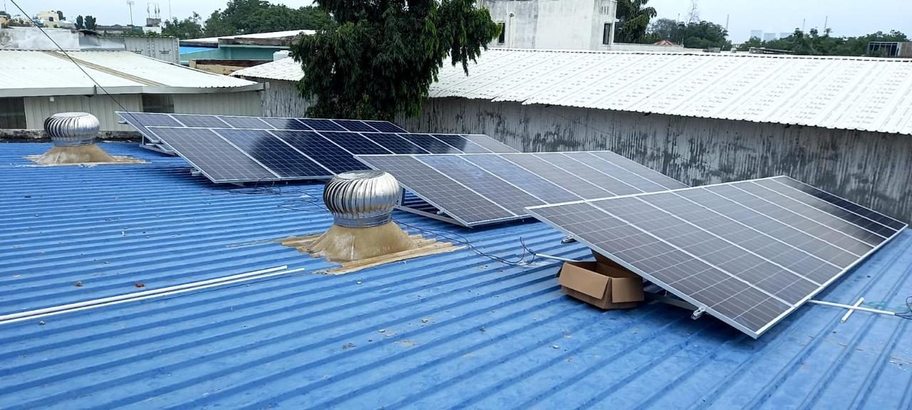 Solar modules mounted on a blue metal roof